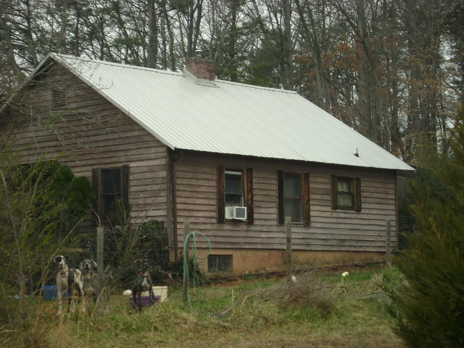 White metal roof on an old wood sided farmhouse, from a Metal Roof Installation job in Finksburg